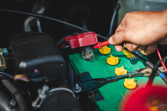 Technician checking on an old car battery