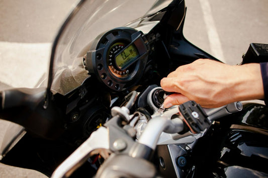 A driver starting up his motorcycle's engine