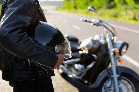 A driver about to board their motorcycle on the road